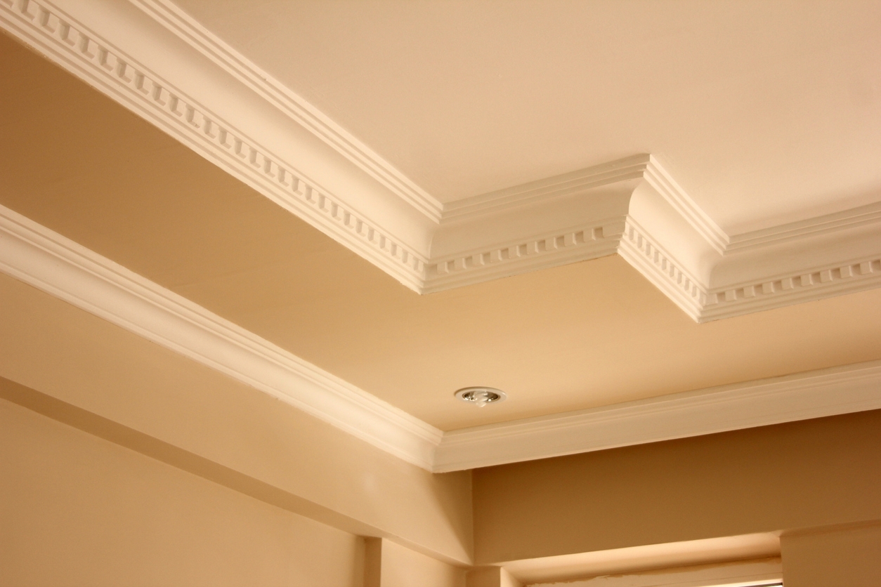 Elegant ceiling with tan and cream paint and crown moulding