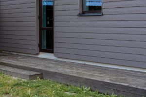Old weathered wooden deck and new facade of a modern house in Dublin, CA