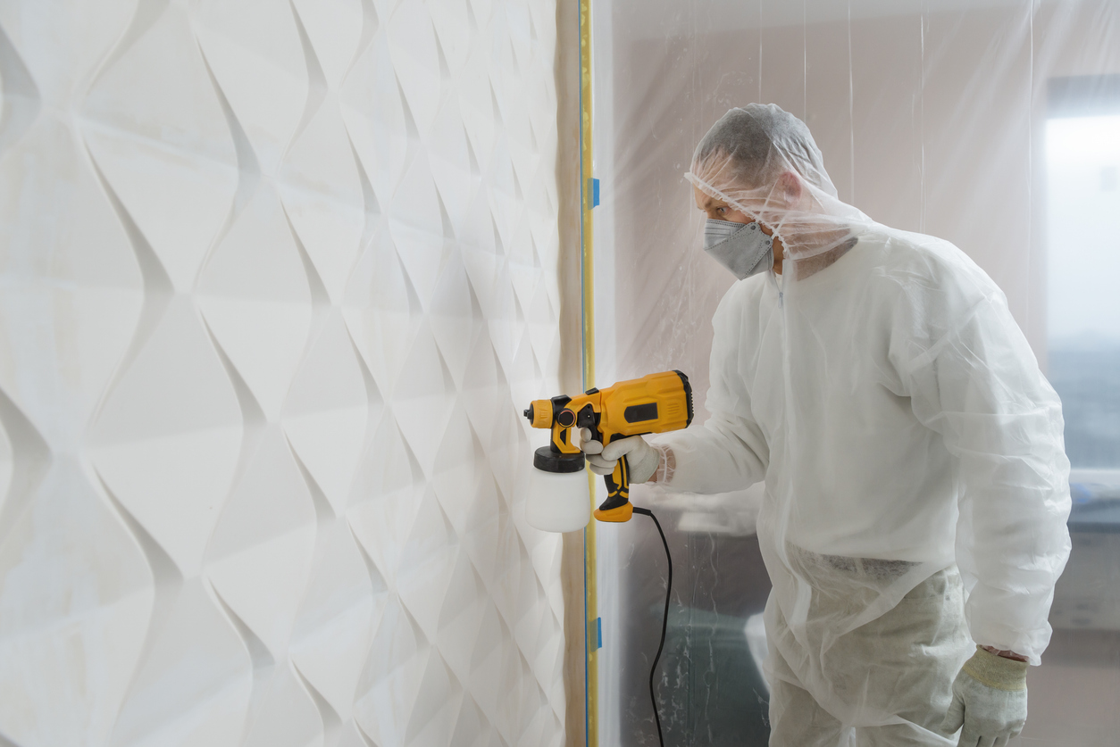 A professional painter is painting a 3d wall using a paint sprayer in Fremont