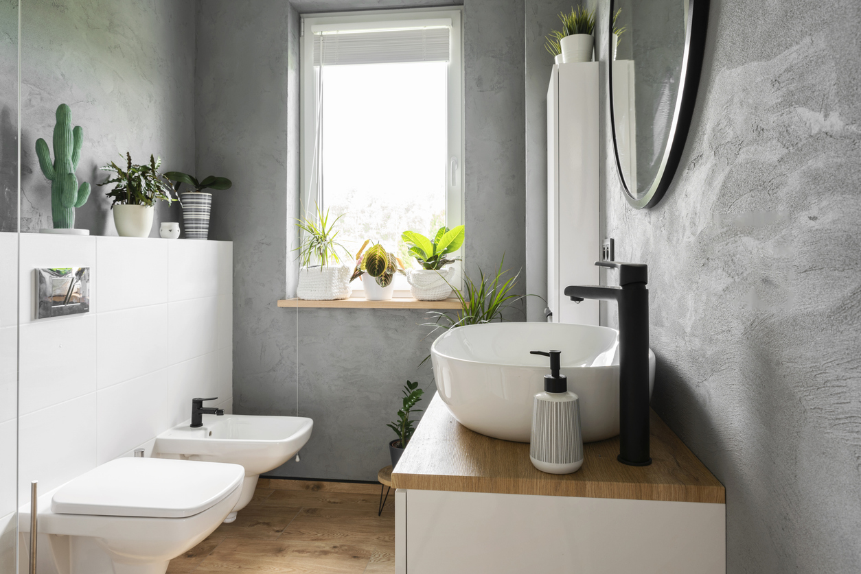 Design bathroom with window in industrial style in loft apartment.